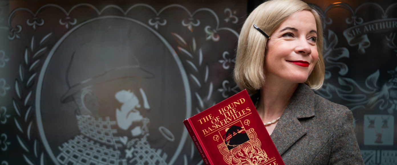 Lucy Worsley holds a red hardback copy of The Hound of the Baskervilles by Sir Arthur Conan Doyle.