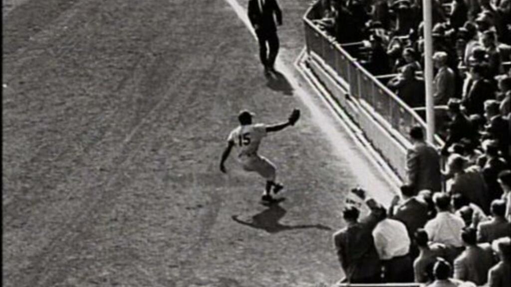 baseball player catching the ball on the field