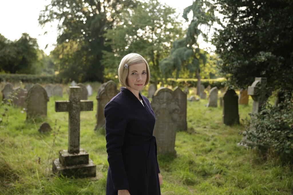 Lucy Worsley in a graveyard.